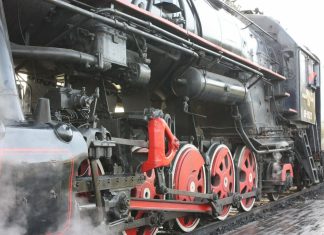black and red train on rail tracks