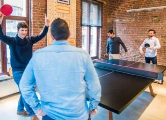 four men playing table tennis
