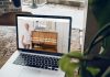 MacBook Pro on top of brown wooden table during daytime